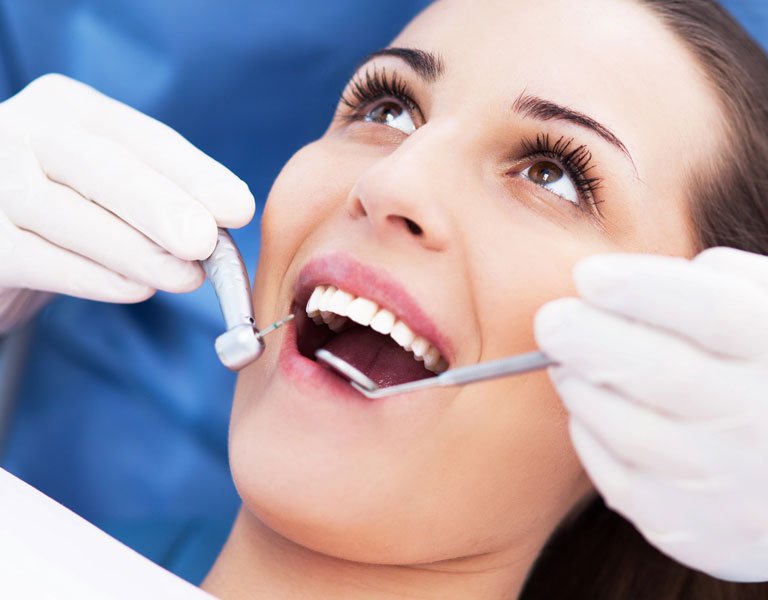 Dentist examining a patient’s teeth at a dental office in Stafford, VA