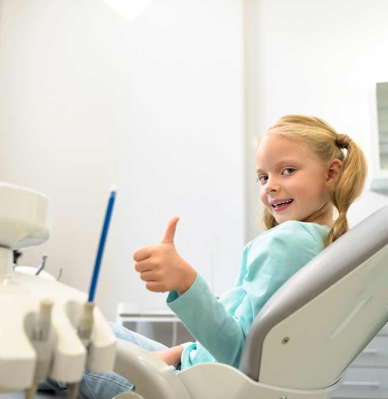 Happy little child sitting in a dental chair at a dental clinic in Stafford, VA