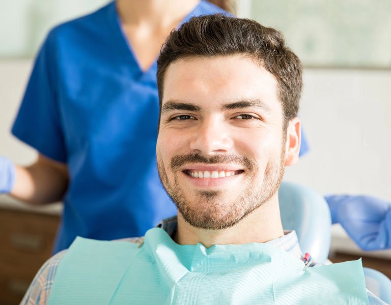 Smiling man getting ready for dental treatment at a dental clinic in Stafford, VA