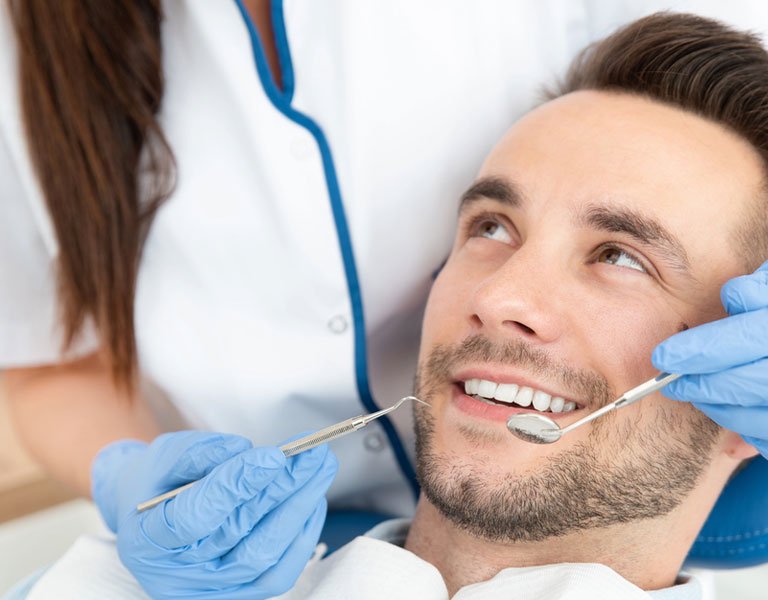 Man having a dental exam in Stafford, VA