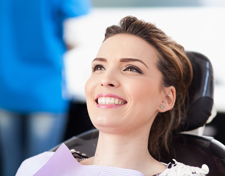 A joyfull woman ate a dental clinic