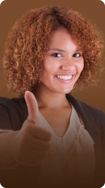 A smiling woman giving a thumbs-up