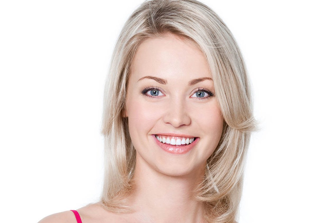 Smiling patient with healthy teeth after safe mercury filling removal at a Stafford, VA dental clinic specializing in metal-free dentistry